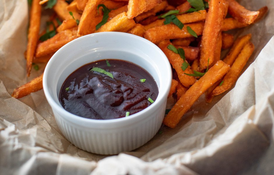 A side of ketchup demonstrating viscosity and shear stress next to a serving of french fries.